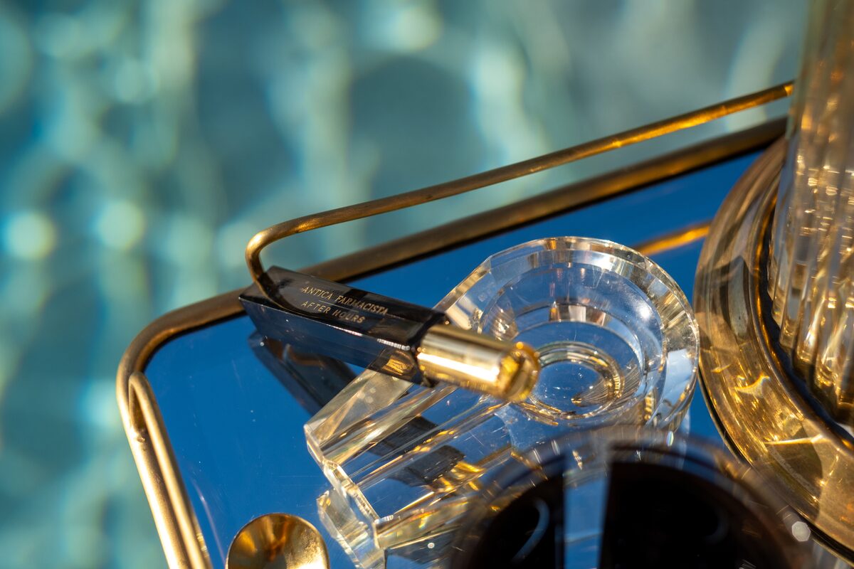 The After Hours mini on a mirrored tray reflecting sky and water.